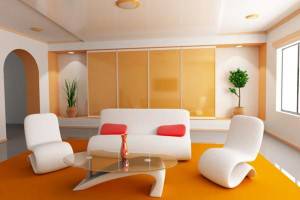 Moderna sala de estar con un sofá blanco acentuado por cojines rojos, dos sillones blancos, una mesa de centro de vidrio y plantas decorativas,