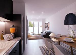 Una moderna cocina y comedor de planta abierta con un diseño elegante, que cuenta con un refrigerador, una mesa de comedor para cuatro personas y una sala de estar visible al fondo luego de su reconversión de un al.